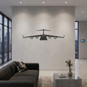 Czarna stalowa ozdoba w kształcie samolotu Boeing C-17 Globemaster na szarej ścianie nad brązową kanapą w salonie